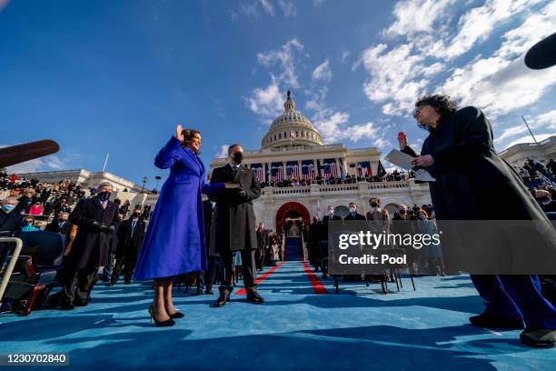 Kamala Harris is sworn in as vice president by Supreme Court Justice Sonia Sotomayor as Harris's husband Doug Emhoff holds the Bible on the West...