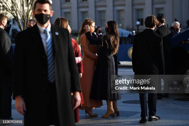 Ashley Biden, daughter of U.S. President Joe Biden, adjusts the hair of her niece, Natalie Biden, before their family walked along the abbreviated...