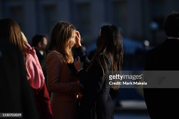 Ashley Biden, daughter of U.S. President Joe Biden, adjusts the hair of her niece, Natalie Biden, before their family walked along the abbreviated...