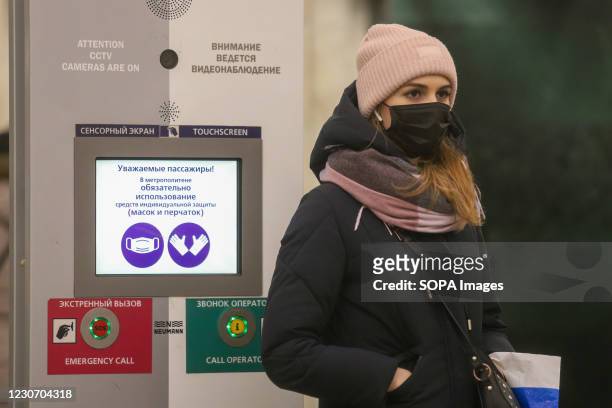 Woman wearing a face mask as a protective measure against the spread of coronavirus walks around the subway station amid coronavirus crisis. Russia...