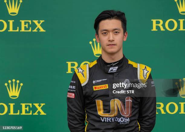 This photo taken on July 13, 2019 shows Chinese driver Zhou Guanyu reacting after taking third place at a feature race during the seventh round of...