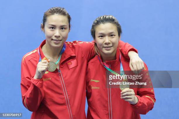 Gold medalist Wang Han and Shi Tingmao of China celebrate during the medal ceremony after the Women's Synchronised 3m Springboard Final on day one of...