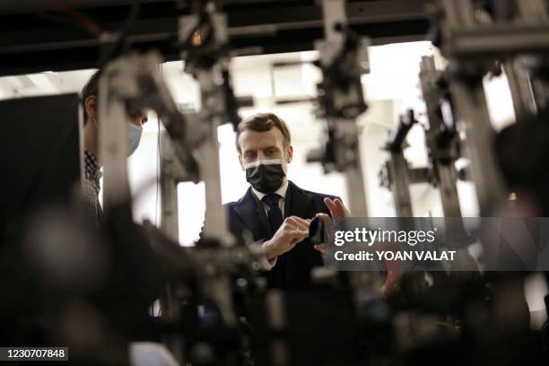 French President Emmanuel Macron is welcomed as he arrives for a visit to the Centre de Nanosciences et de Nanotechnologies of the French National...