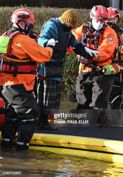 Members of the Emergency services, wearing face mask coverings due to the COVID-19 pandemic, work to evacuate Care Home residents after they became...