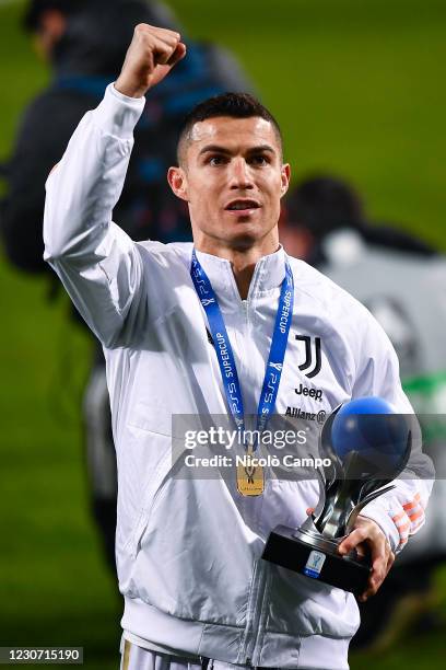 Cristiano Ronaldo of Juventus FC celebrates with MVP trophy during the awards ceremony at end of the Italian PS5 Supercup football match between...