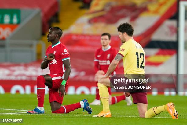 Liverpool's Senegalese striker Sadio Mane and Burnley's Irish midfielder Robbie Brady take a knee against racism during the English Premier League...