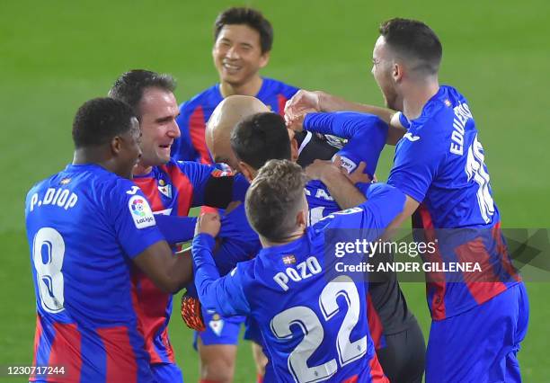 Eibar's players celebrate after Eibar's Serbian goalkeeper Marko Dmitrovic scored during the Spanish league football match SD Eibar against Club...