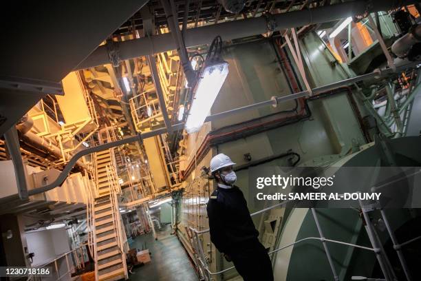 Mariner of the container ship "CMA CGM Jacques Saade" patrols in the engine room, in the container ship "CMA CGM Jacques Saade", at the harbour of Le...