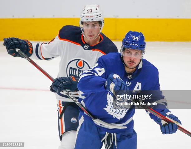 Edmonton Oilers center Ryan Nugent-Hopkins uses his stick to slow down Toronto Maple Leafs center Auston Matthews . Toronto Maple Leafs vs Edmonton...