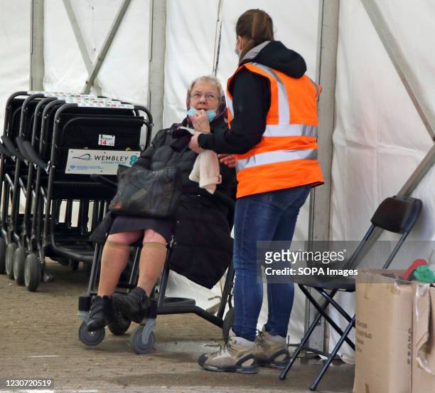 Steward attends to an elderly woman inside the vaccination centre entrance. A steady stream of elderly people with pre-booked appointments at the new...