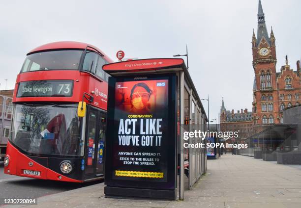 Act Like You've Got It' sign is pictured at a bus stop in King's Cross, London.England remains under lockdown as the government battles to keep the...
