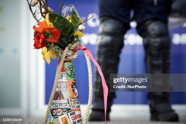 Someone has put a flowers bouquet near a riot poilceman . Culture workers and activists organized a performance in the streets of Toulouse to protest...