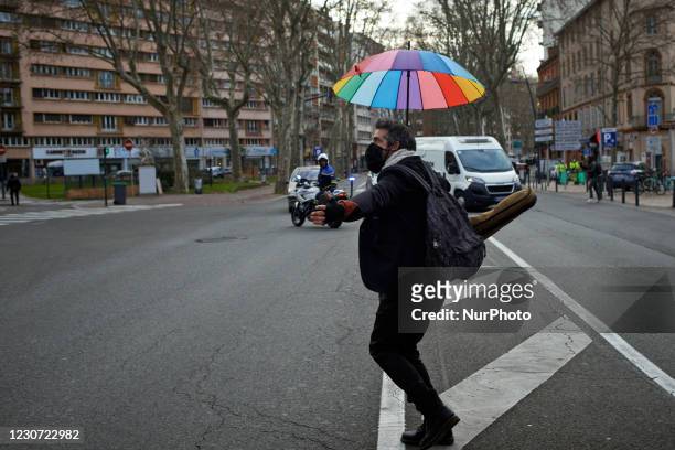 Musician walks in the middle of a crossroads. Culture workers and activists organized a performance in the streets of Toulouse to protest against the...