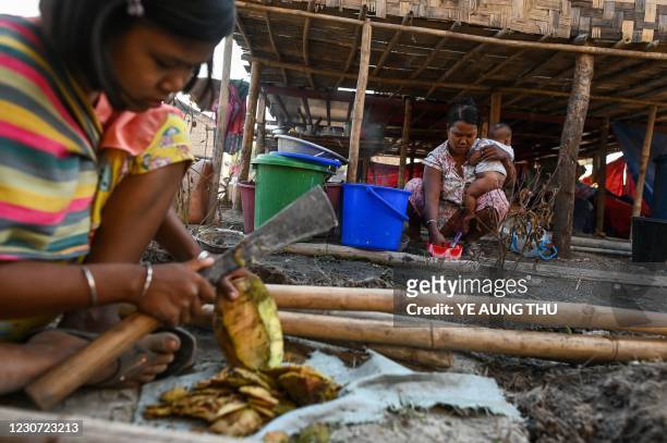 This photo taken on January 11, 2021 shows Chin people preparing food in Bethel village in Hmawbi, on the outskirts of Yangon, where hundreds of...