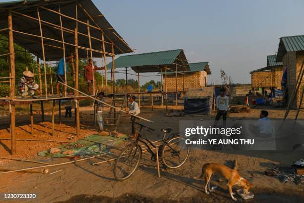 This photo taken on January 11, 2021 shows members of the Chin community building a house in Bethel village in Hmawbi, on the outskirts of Yangon,...