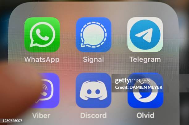 This picture taken on Januray 22, 2021 in Rennes, western France, shows a smartphone screen featuring messaging service applications WhatsApp,...