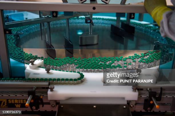 An assembly line for manufacturing vials of Covishield, AstraZeneca-Oxford's Covid-19 coronavirus vaccine is pictured at India's Serum Institute in...