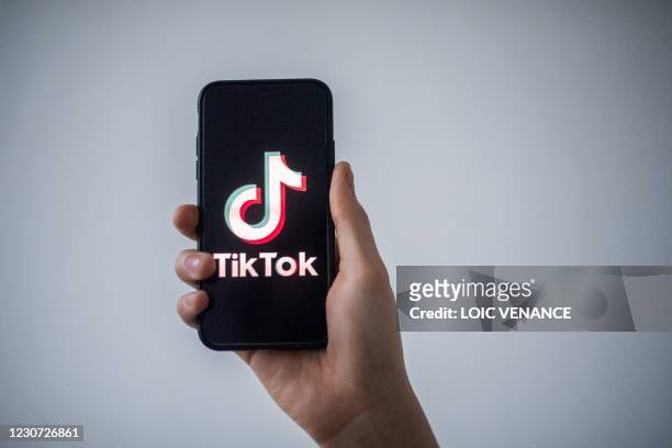 Picture taken on January 21, 2021 in Nantes, western France shows a smartphone with the logo of Chinese social network Tik Tok.