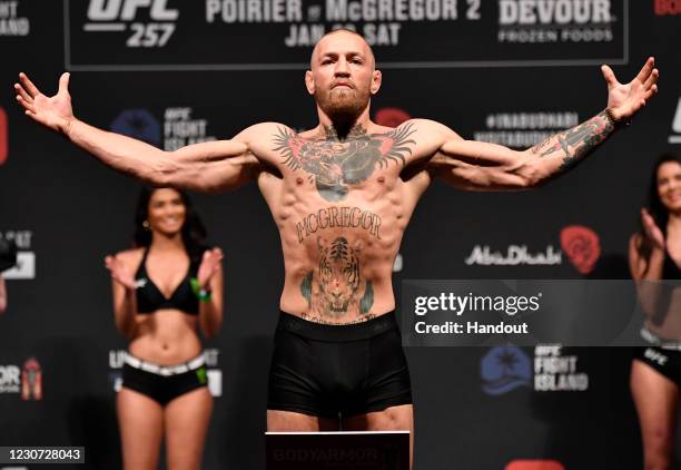 In this handout image provided by the UFC, Conor McGregor of Ireland poses on the scale during the UFC 257 weigh-in at Etihad Arena on UFC Fight...
