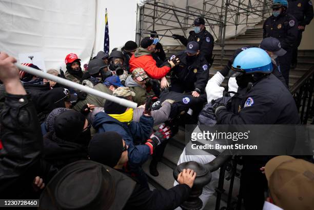 Trump supporters clash with police and security forces as people try to storm the US Capitol in Washington D.C on January 6, 2021. Demonstrators...