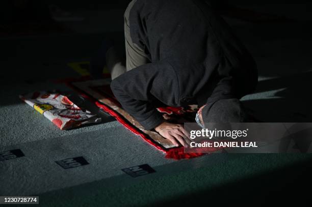 Muslim man attends socially distanced Friday Prayers at the Baitul Futuh Mosque of the Ahmadiyya Muslim Community in south west London on January 22,...