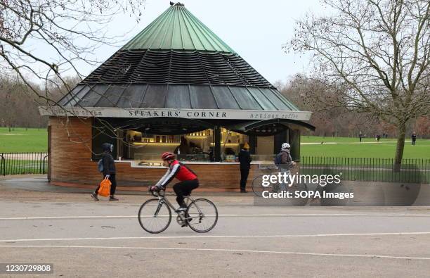 Cyclists ride past a Speakers Corner cafe in Hyde Park. England remains under lockdown as the Prime Minster Boris Johnson refuses to rule out that it...