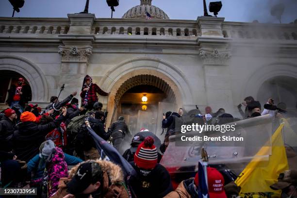 Trump supporters clash with police and security forces as people try to storm the US Capitol on January 6, 2021 in Washington, DC. - Demonstrators...