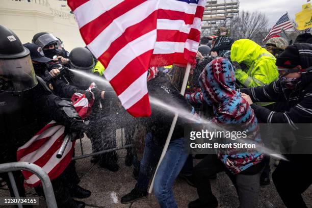 Trump supporters clash with police and security forces as people try to storm the US Capitol on January 6, 2021 in Washington, DC. Demonstrators...