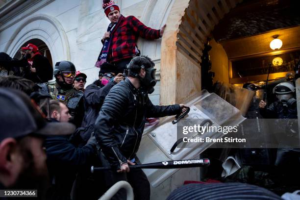 Trump supporters clash with police and security forces as people try to storm the US Capitol on January 6, 2021 in Washington, DC. - Demonstrators...