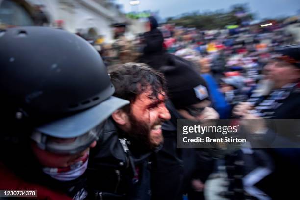 Trump supporters clash with police and security forces as people try to storm the US Capitol on January 6, 2021 in Washington, DC. - Demonstrators...