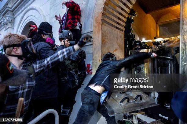 Trump supporters clash with police and security forces as people try to storm the US Capitol on January 6, 2021 in Washington, DC. - Demonstrators...