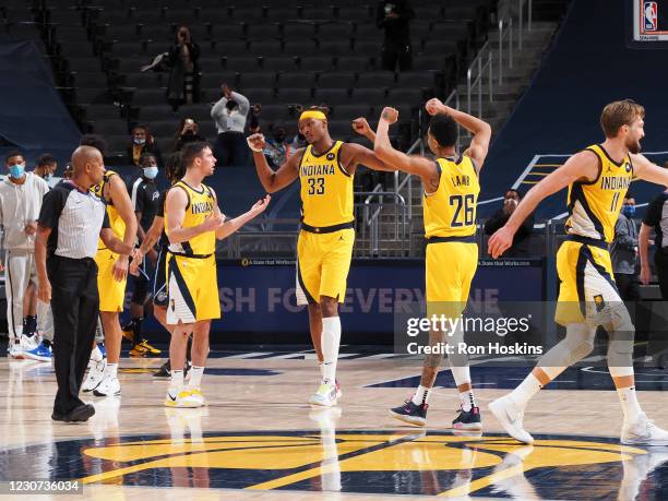 Myles Turner of the Indiana Pacers, Jeremy Lamb of the Indiana Pacers and T.J. McConnell of the Indiana Pacers celebrate their overtime win over the...