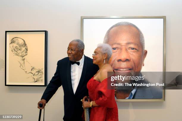 Baseball legend Hank Aaron with his wife, Billye Aaron pause for a photograph in front of his portrait hanging at the National Portrait Gallery...