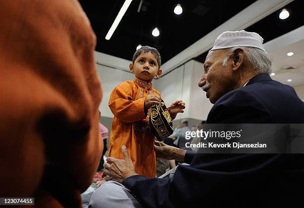 Seventeen months -old Pakistani Muslim Ali Khaja attends special Eid ul-Fitr morning prayer eith his grandfather Ahsan Khaja at the Los Angeles...