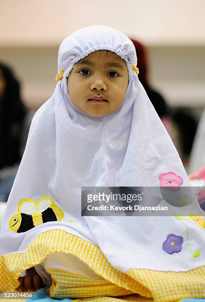 Indonesian Muslim four years-old Mutiara Sarwono and her family gather with fellow Muslims from across the Southland for the special Eid ul-Fitr...