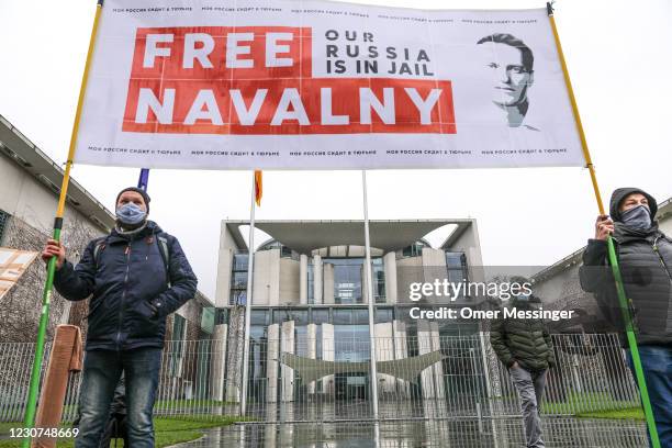 Protesters hold a banner reading "FREE NAVALNY" in front of the Federal Chancellery, as some 2,500 supporters of Russian opposition politician Alexei...