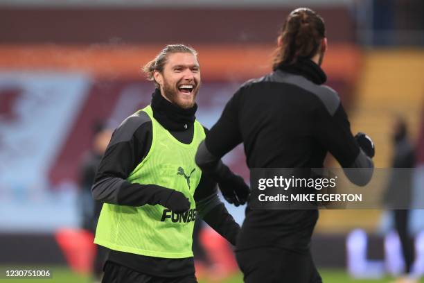 Newcastle United's Irish midfielder Jeff Hendrick warms up with Newcastle United's English striker Andy Carroll ahead of the English Premier League...