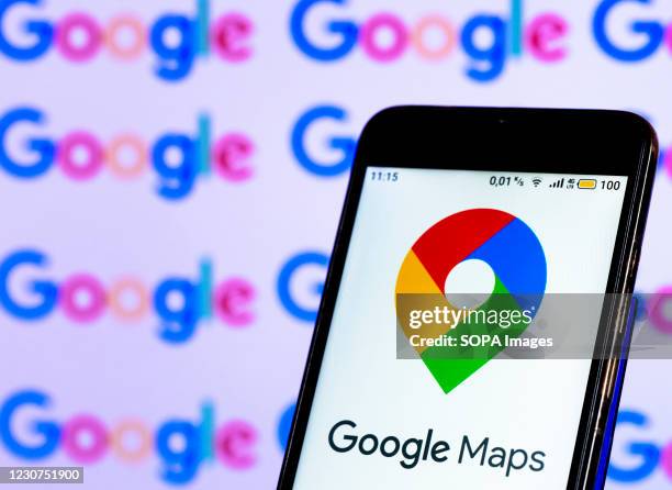 In this photo illustration a Google Maps logo seen displayed on smart phone screen on the background of a computer screen.