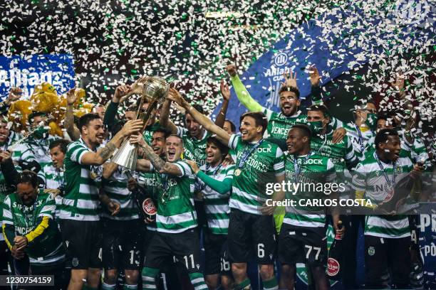 Sporting players celebrate with their trophy after winning the Portuguese Taca da Liga final football match between Sporting CP and SC Braga at the...