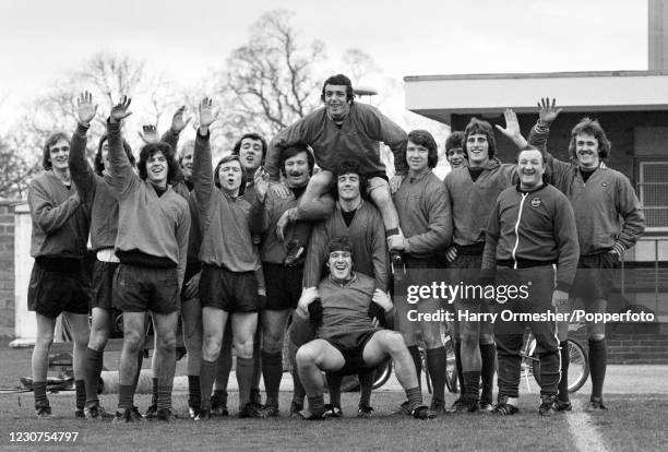 Footballer Ian Callaghan, on the shoulders of Kevin Keegan, receives the congratulations from his team mates after he was awarded an MBE in the New...