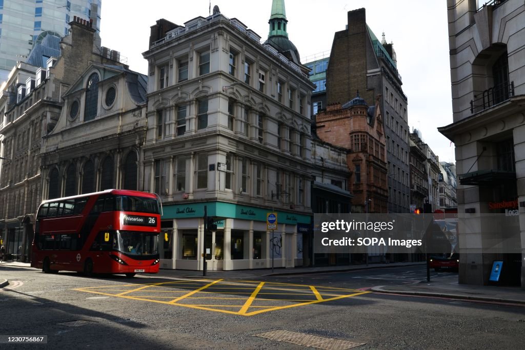 A bus drives on an empty Gracechurch Street during the third...