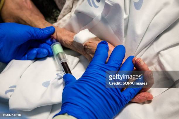 Health worker draws blood for analysis from a patient believed to be positive of covid19 in a ward at the University Hospital of São João do Porto....