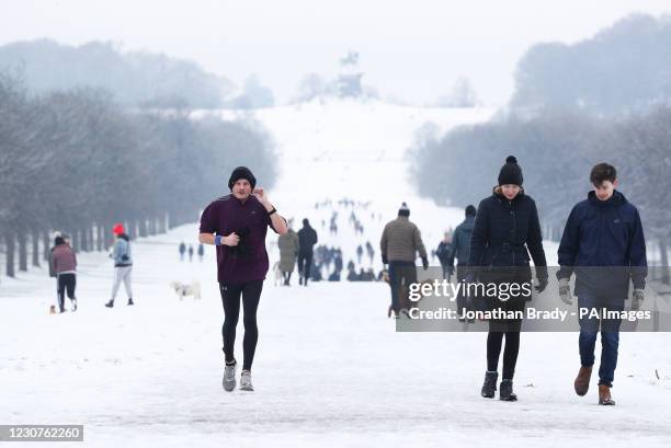 People in the snow on the Long Walk at Windsor Castle, Berskhire. Picture date: Sunday January 24, 2021.