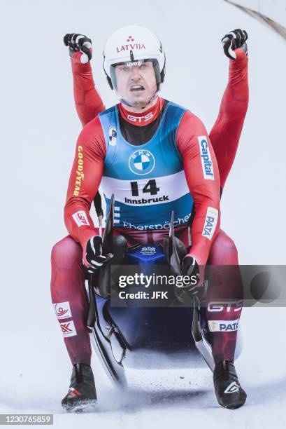 Winners Latvia's Andris Sics and Juris Sics celebrate after the men's doubles competition of of the Luge World Cup at the Olympia Eiskanal in...