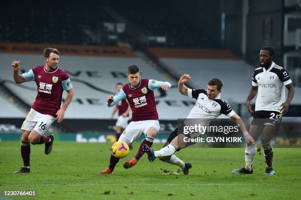 Fulham's English defender Joe Bryan vies for the ball against Burnley's Icelandic midfielder Johann Berg Gudmundsson during the English FA Cup fourth...