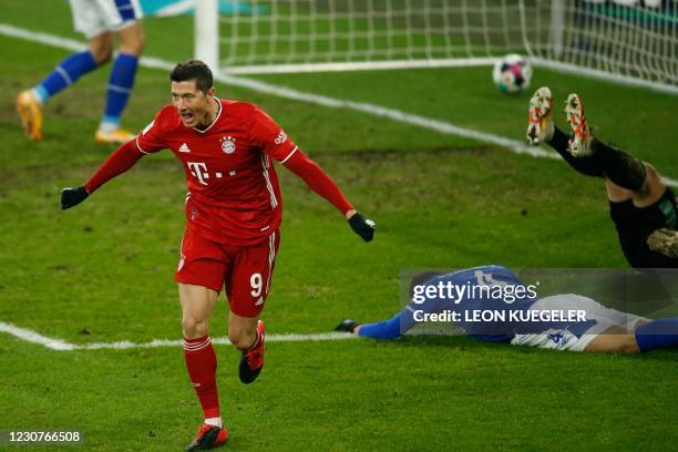 Bayern Munich's Polish forward Robert Lewandowski celebrates scoring the 0-2 goal during the German first division Bundesliga football match Schalke...