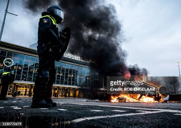 Car has been set on fire in front of the train station, on January 24, 2021 in Eindhoven, after a rally by several hundreds of people against the...