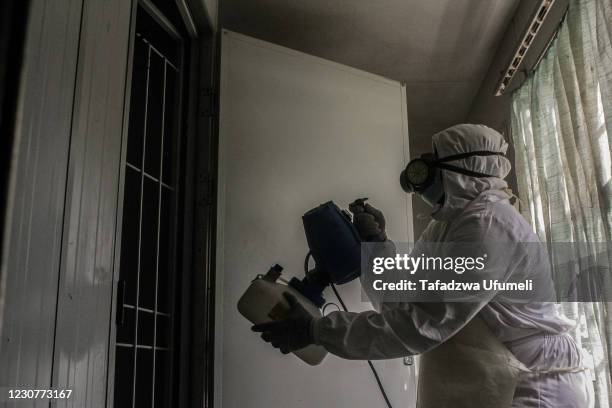 Man disinfects an office using a fogging machine at a toll gate on January 24, 2021 in Chinhoyi, Zimbabwe. The Deep Cleaning company is disinfecting...