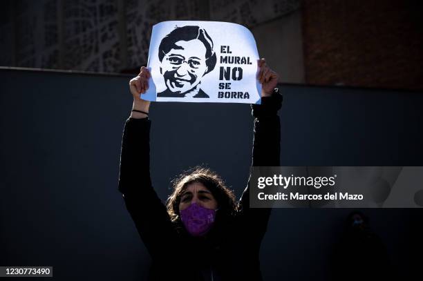 Woman holds a placard with the picture of Rosa Parks and the words 'the mural should not be erased', during a protest against the removal proposed by...