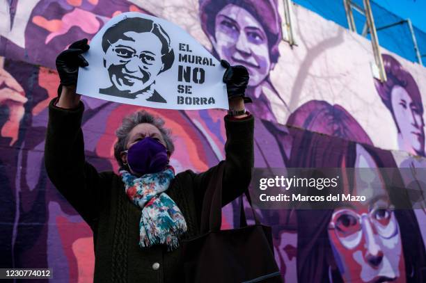 Woman holds a placard with the picture of Rosa Parks and the words 'the mural should not be erased', during a protest against the removal proposed by...